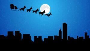 Christmas Santa reindeer sleigh flying over the city